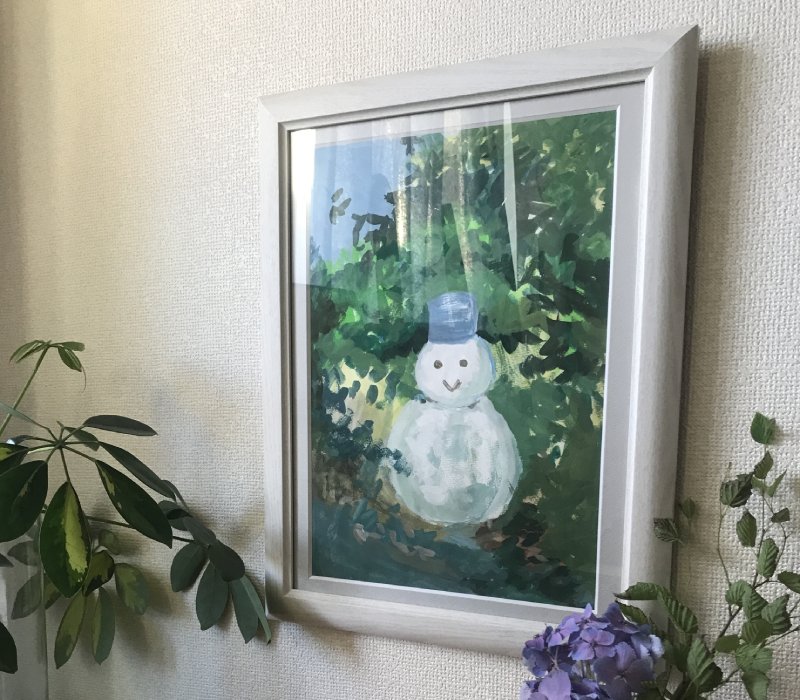 A framed watercolor of a snowman